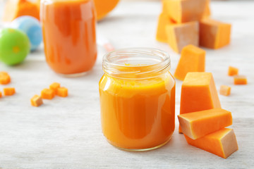 Jar with baby food on table