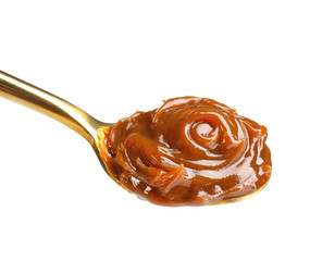 Spoon with delicious caramel sauce on white background