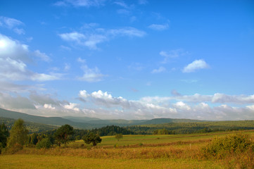Landscape of Polish Beskids - hills, boulders, forests and blue sky