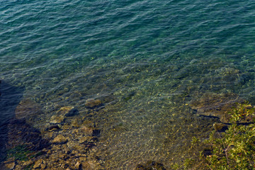 sea with a stone bottom and a blue clear water