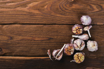 Fototapeta na wymiar Garlic. On a wooden background. Top view. Free space for your text.