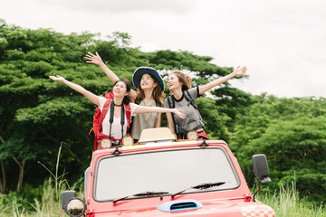 Happy Asian women friends backpacker enjoy nature during vacation travel trip in forest.