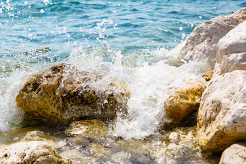 waves break against the rocks 