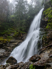 Fototapeta premium large Waterfall from ravine in autumn, long exposure