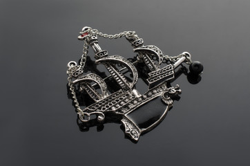 silver brooch ship with diamonds isolated on black