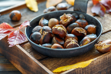 Roasted chestnuts in a cast iron skillet.