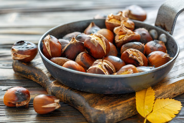 Roast chestnuts in a pan closeup.