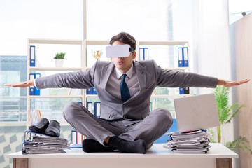 Businessman with VR virtual reality glasses in office