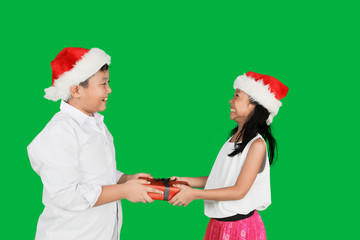 Boy giving presents to his sister in studio