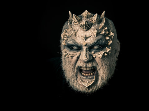 Evil face with dragon skin and grey beard