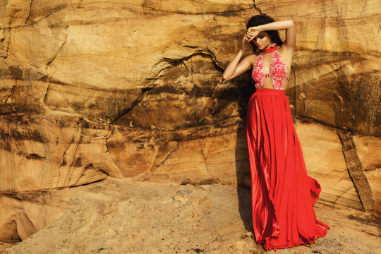Beautiful and sensual woman wearing luxury red dress