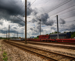 Fototapeta na wymiar railway infrastructure, freight wagons are waiting for transport, atmospheric sky.