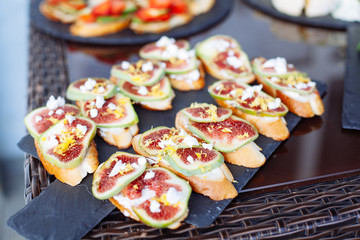 Catering banquet table with different food snacks and appetizers