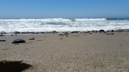 Fototapeta na wymiar Waves on rocky beach series - sand level