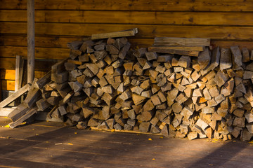 Chopped wood under a canopy in a village house