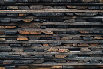 Wooden brown background is from lying horizontally boards. beams wooden boards lying on each other on the market for sale