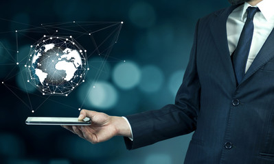 Businessman touch tablet PC screen with blue internet globe