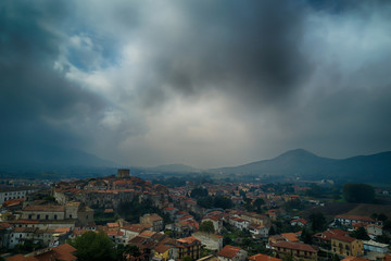 Fototapeta na wymiar Medieval italian old village aerial view with clouds and mountains