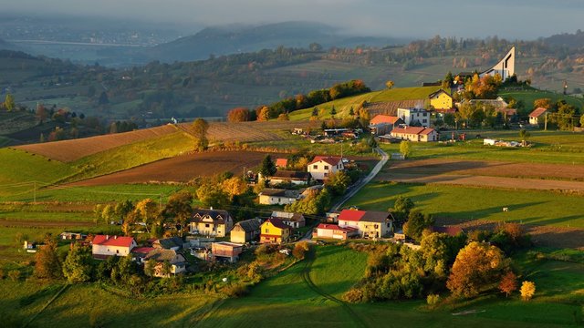 Fall landscape in Slovakia. Rural countryside in Polana region. Fields and meadows with autumn trees in Hrinova at sunrise.