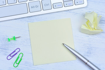 Notes with pen and computer keyboard on desk