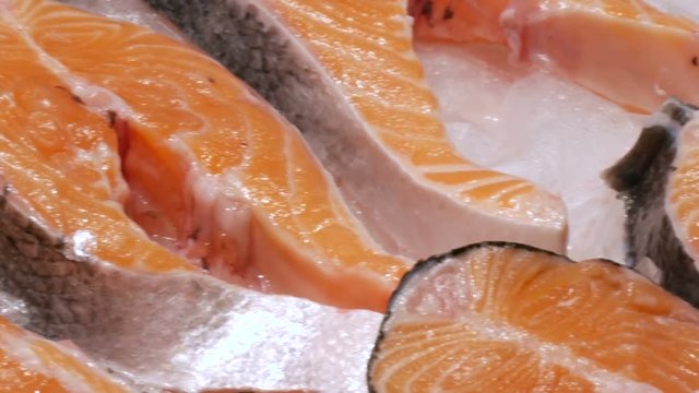 Juicy fresh tasty red fish fillets on the fish market in ice close up view