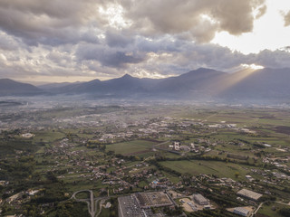 Aerial view of a cloudy day in an Italian countryside at sunset