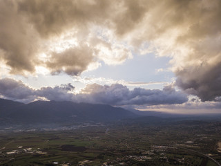 Aerial view of a cloudy day in an Italian countryside at sunset