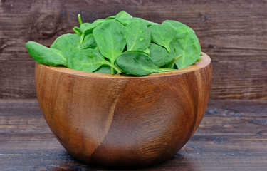 Baby spinach in a bowl on table
