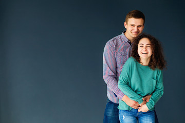 Joyful cute couple embraces. The concept of a successful relatio