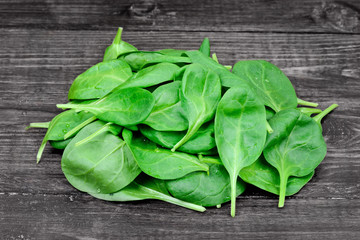 Heap of fresh green baby spinach on table