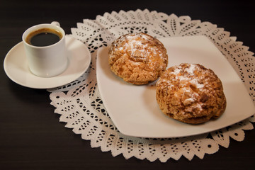 Choux cream or cream puff and coffee on dark background. Selective focus.