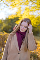 Girl doubting, thoughtful in the autumn park