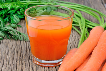 Fresh carrot juice in a glass on table