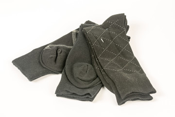 Pile of mens black socks isolated on white background