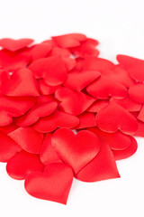 Pile of red hearts isolated above white background. Love and rom