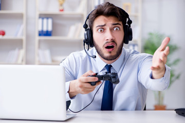 Businessman gamer in office playing games