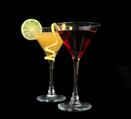 Two cocktails cosmopolitan cocktails decorated with citrus lemon twist yellow