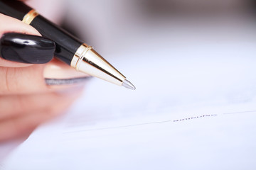 Hands of business woman signing the contract document