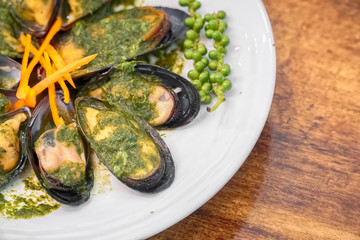 Baked mussels with carrot on plate