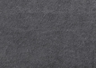 Fototapeta na wymiar Close up shot of black worn denim jeans fabric