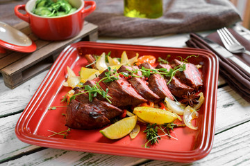 grilled Denver steak on plate with vegetables