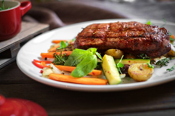 grilled Striploin steak with vegetables on plate