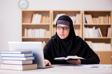 Muslim girl in hijab studying preparing for exams