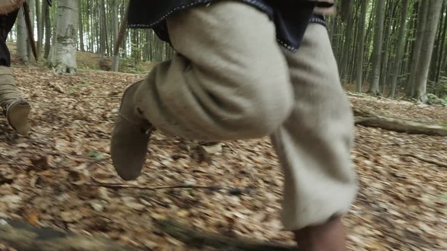 The feets of Vikings running along the slope