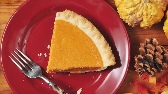 Artistic overhead zoom out shot of a slice of pumpkin pie
