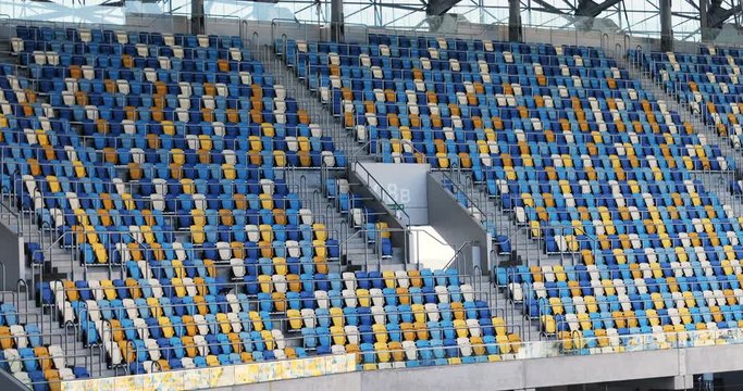 sport field empty seats stadium corner sports arena seating place blue yellow orange colored section chairs nobody plastic bench sit spectators audience sitting sporting events furniture audience