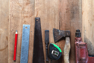 Tool set of carpenter on wooden background