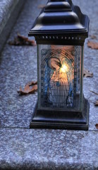 candles burning in the cemetery, gravestones of stone and marble. Angel