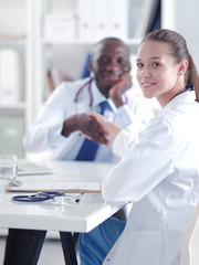 Two happy smiling young medical people handshaking at office. Doctors. Teamwork