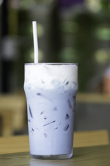 Iced Butterfly Pea Milk on the wooden  table